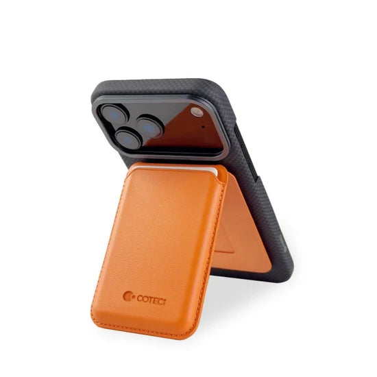 COTECi magnetic card holder phone stand in orange, slim and lightweight wallet accessory for compatible smartphones and magnetic cases with hands-free viewing.
حامل بطاقات مغناطيسي COTECi باللون البرتقالي مع قاعدة للهاتف، تصميم نحيف وخفيف للهواتف والأغطية المتوافقة مع التثبيت المغناطيسي والاستخدام بدون اليدين.